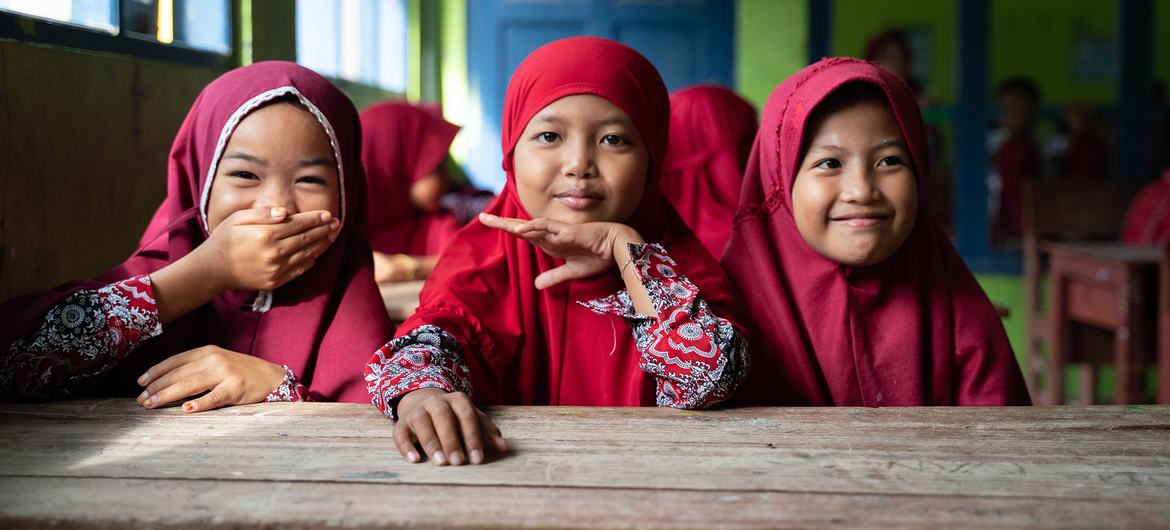Girls await their turns to get immunised at Rusung Raya Elementary School in Indonesia.